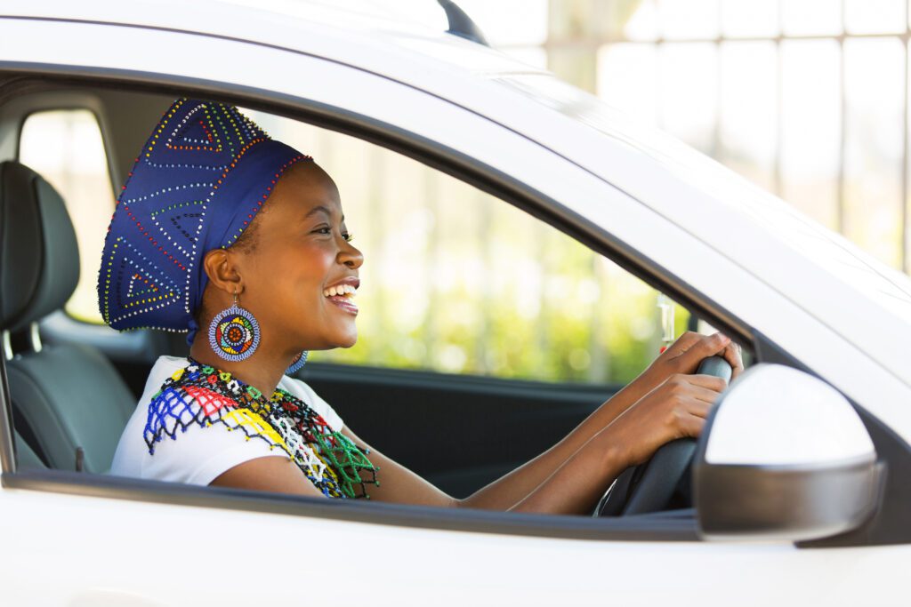 Cheerful African female driver ready for a driving lesson in Durbanville.